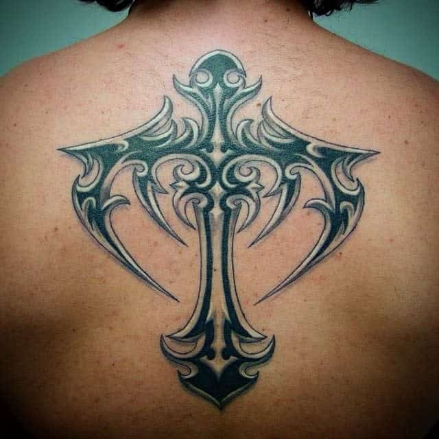 Ornate tattoo featuring a tribal cross pattern in dark ink