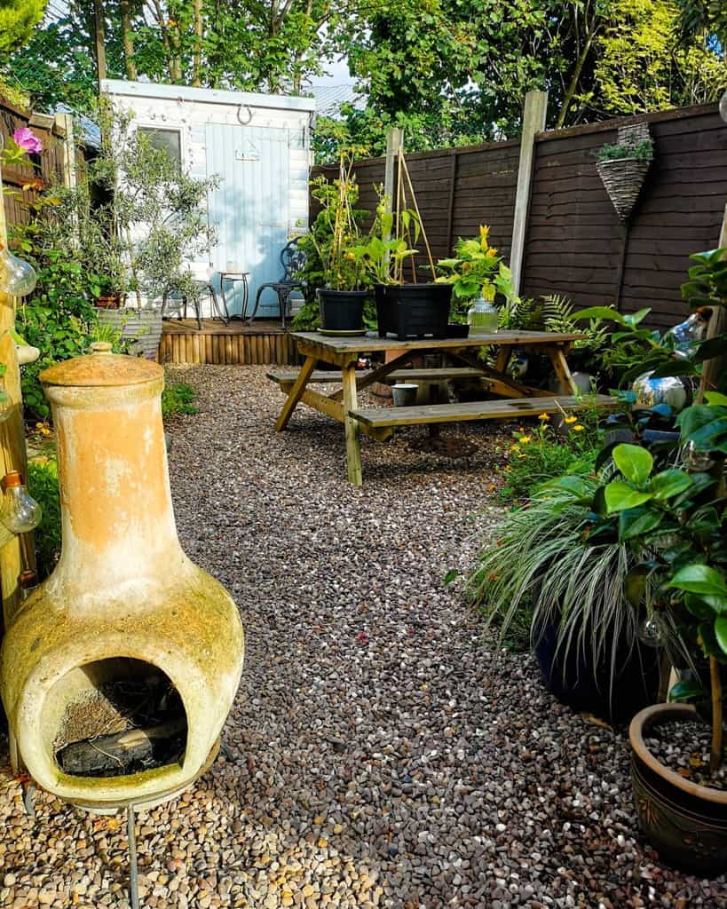 gravel patio with wood park bench 