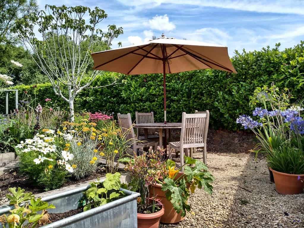 gravel patio with umbrella table and chairs 