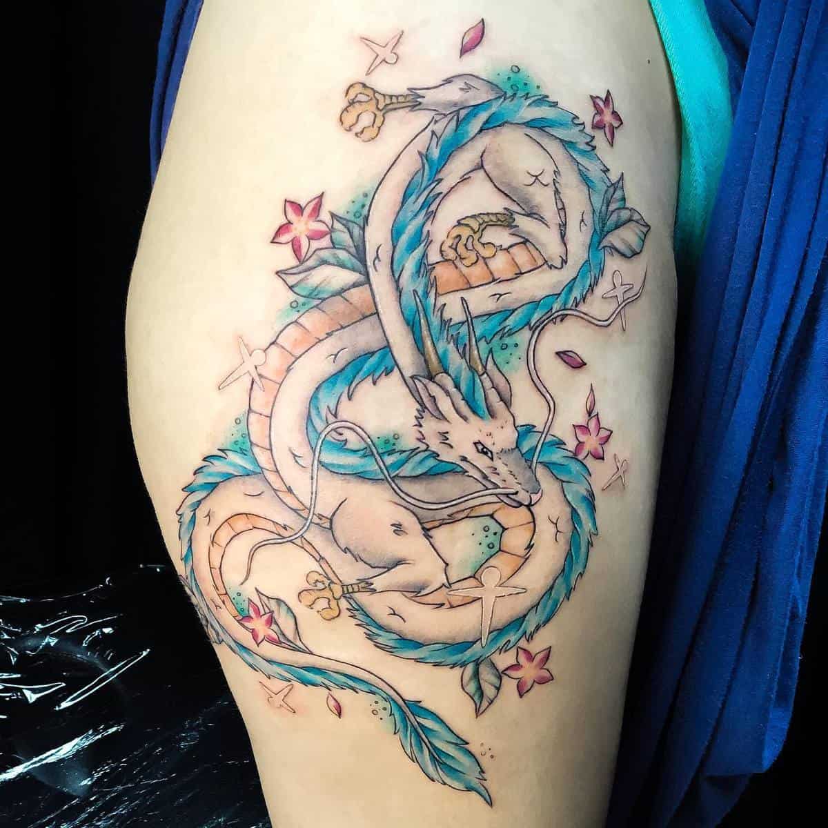 Haku tattoo from Studio Ghibli's Spirited Away, featuring the dragon form with floral accents