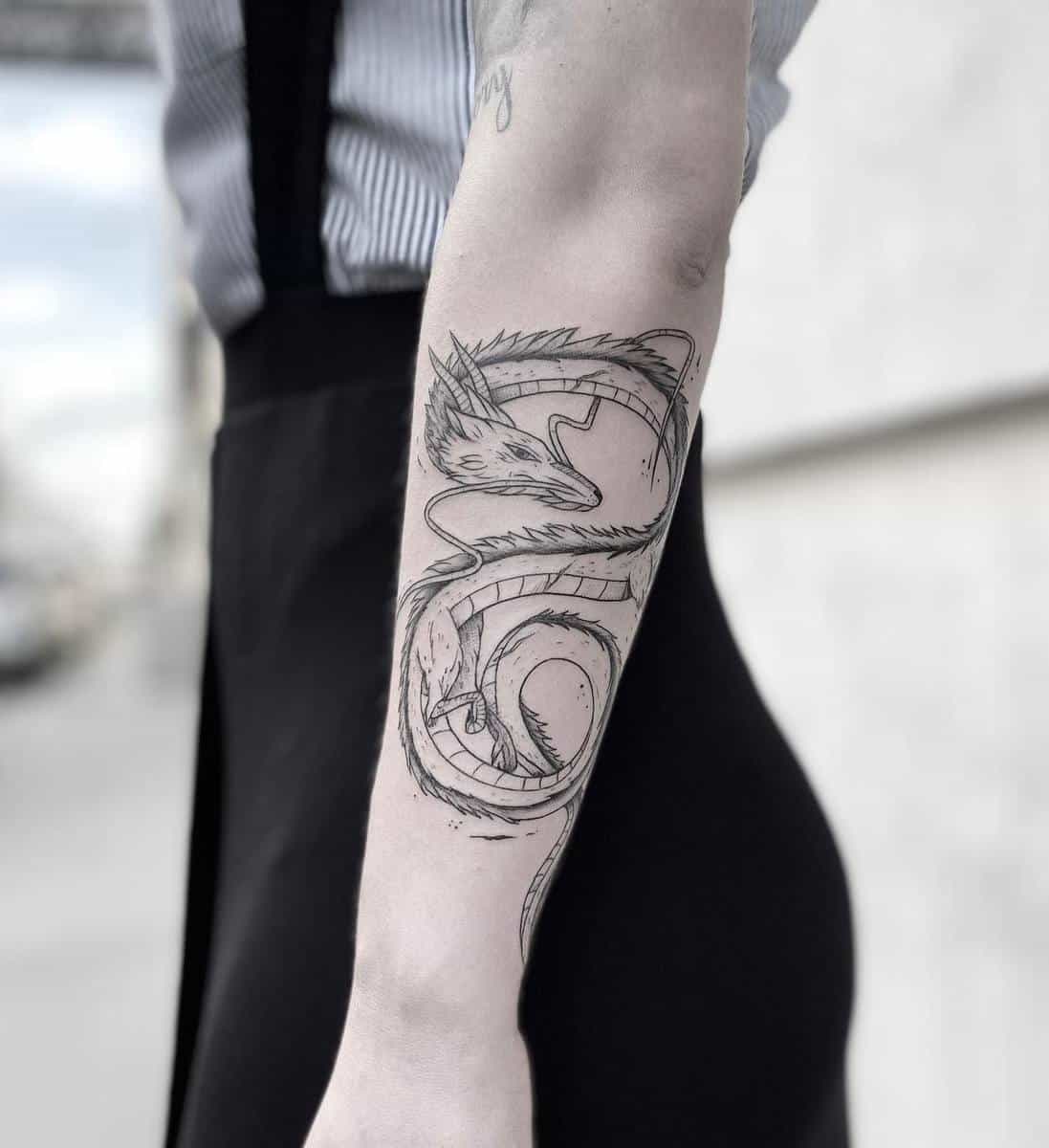 Detailed black and gray tattoo of Haku from Studio Ghibli's Spirited Away on the forearm