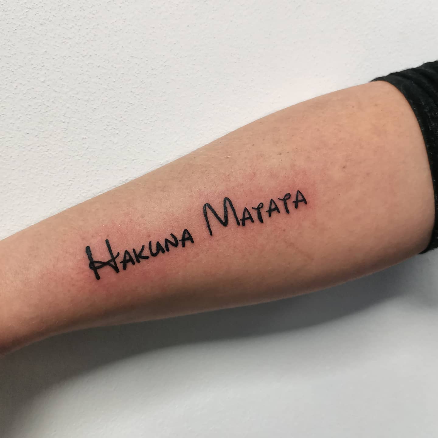Simple Hakuna Matata Arm Tattoo