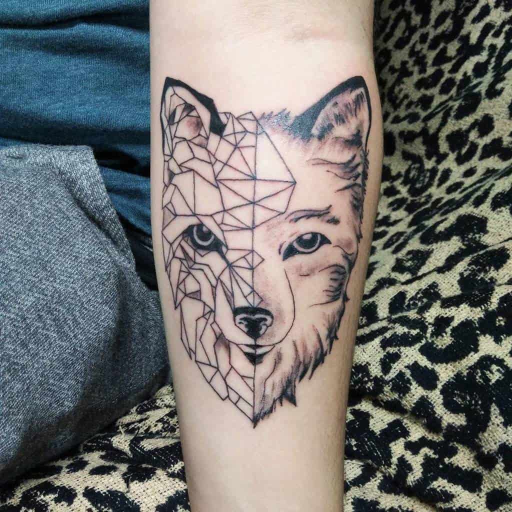 A tattoo of a geometric half wolf and realistic half wolf design on a forearm