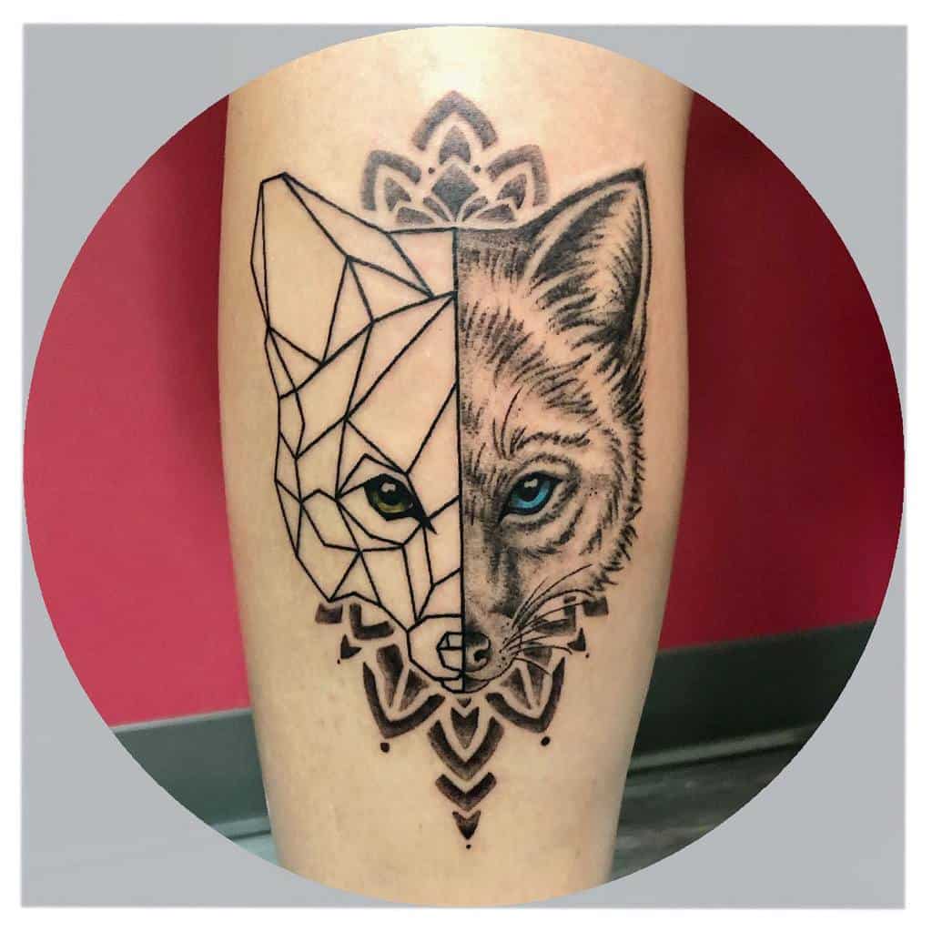 A striking fox tattoo with one half as a realistic fox face and the other in geometric lines, accented with mandala-style elements