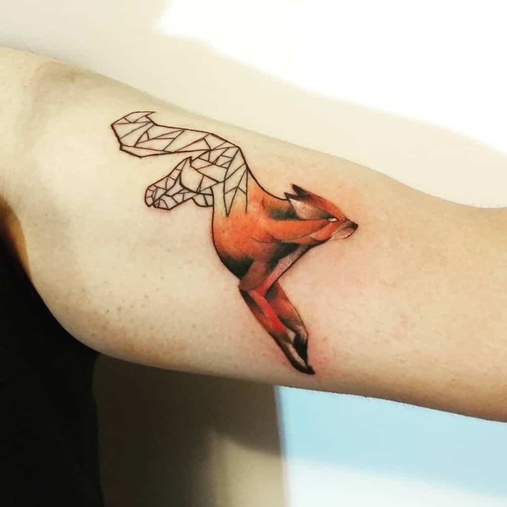 A half-geometric fox tattoo featuring an abstract, angular tail with the body in vivid orange realism