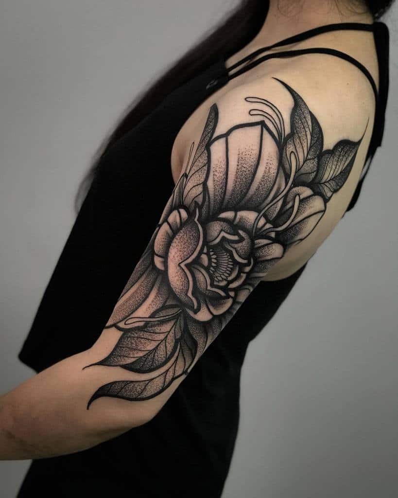 A woman with a detailed floral tattoo on her upper arm