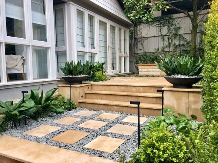 small backyard pavers steps green plants 