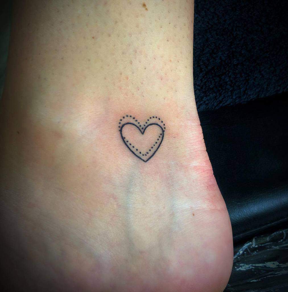 Ankle tattoo of a dotted heart outline