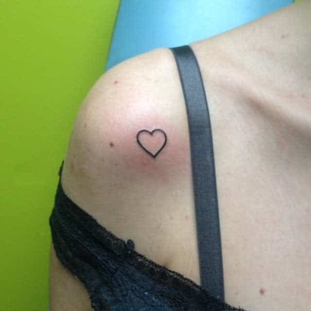 Simple heart outline tattoo on the upper shoulder