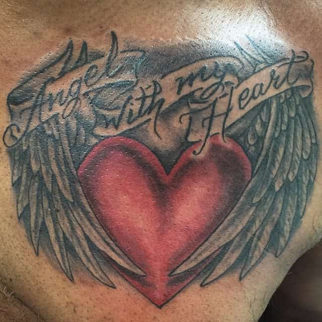 Tattoo of a heart with angel wings and a banner reading "Angel with my Heart" across the chest
