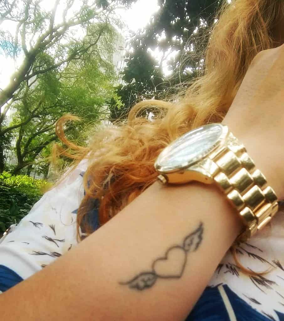 Small heart with wings tattoo on a wrist