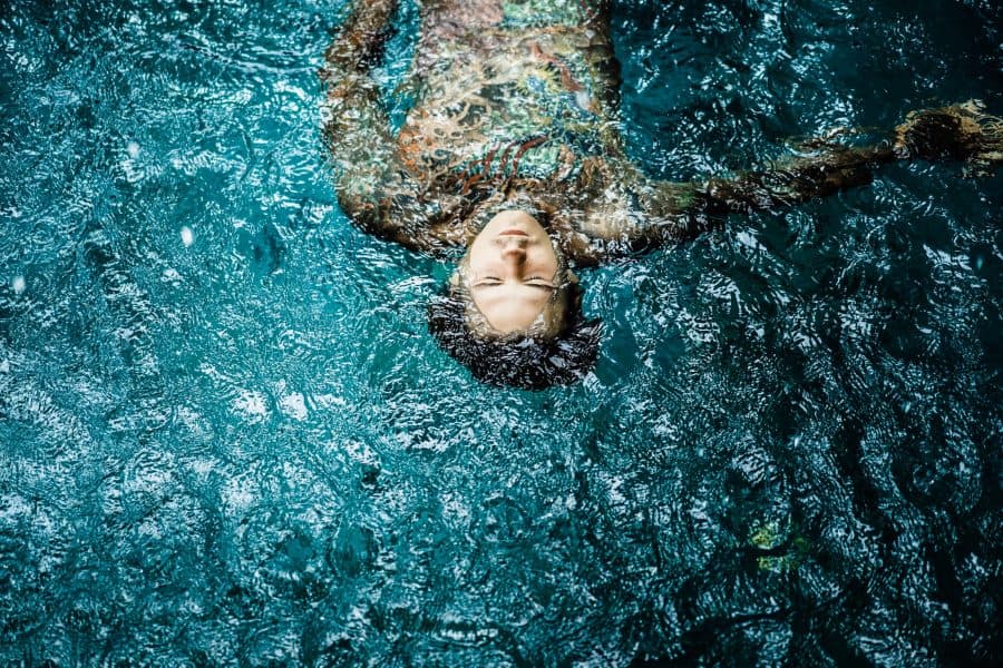 Heavily Tattooed Man Swimming