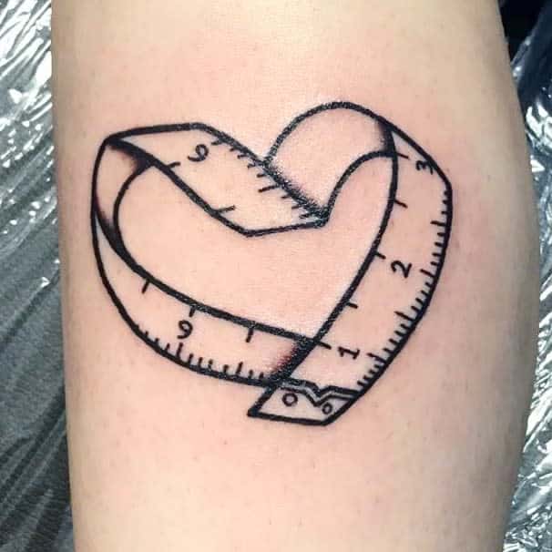 Creative tattoo of a measuring tape shaped into a heart
