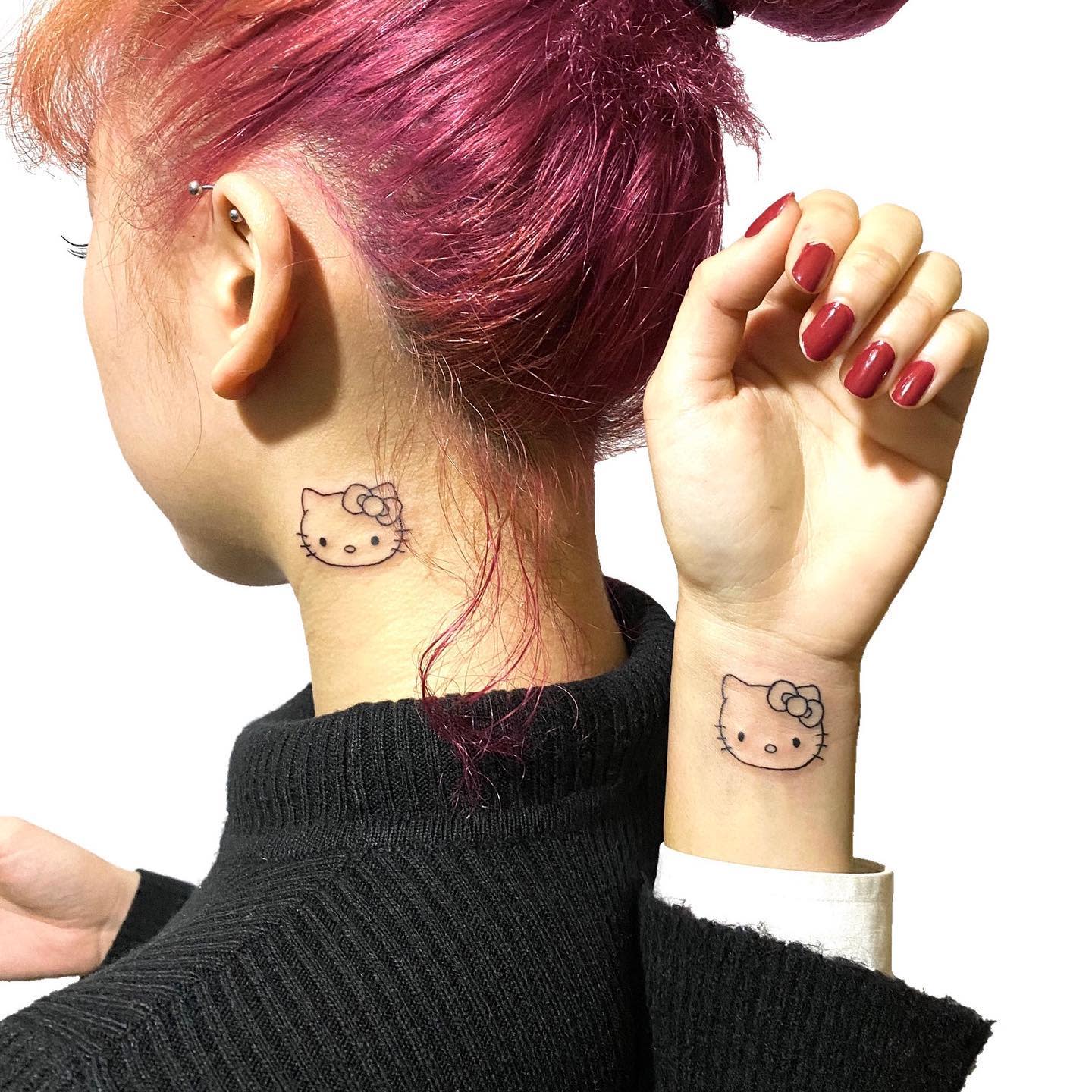 Hello Kitty tattoos on the neck and wrist