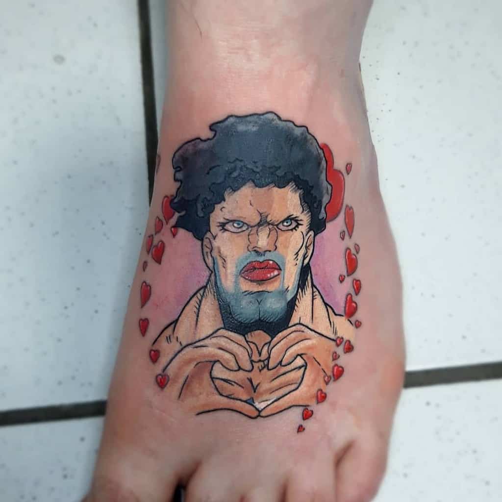A colorful tattoo of Puri-Puri Prisoner from One Punch Man on the foot, making a heart shape with his hands, surrounded by red hearts