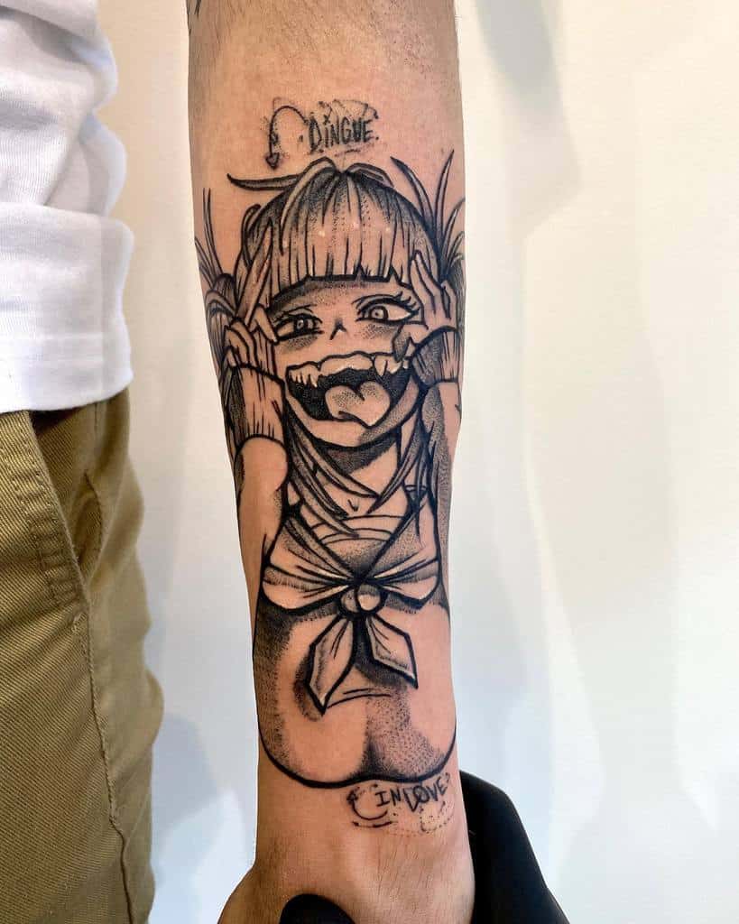 Black and grey tattoo of Himiko Toga from My Hero Academia, featuring her wide grin, sharp teeth, and playful expression, with the word "Dingue" and arrow down above