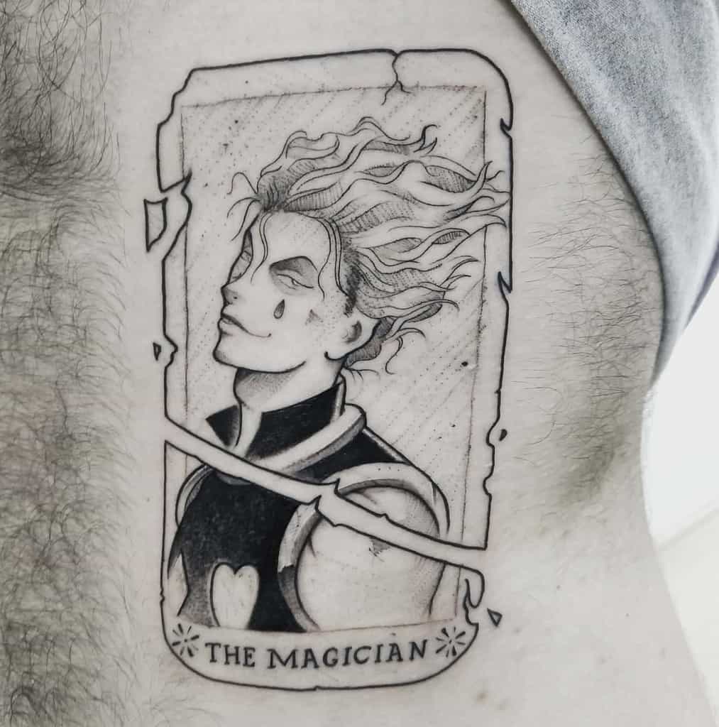 Elegant black-and-grey tattoo of Hisoka Morow from Hunter x Hunter, styled as 'The Magician' tarot card with intricate linework
