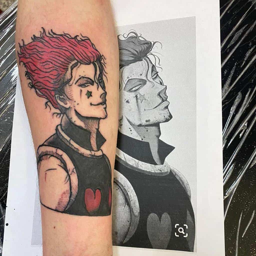 Colorful Hisoka Morow tattoo from Hunter X Hunter, capturing his signature smirk, red hair, and iconic star and heart symbols