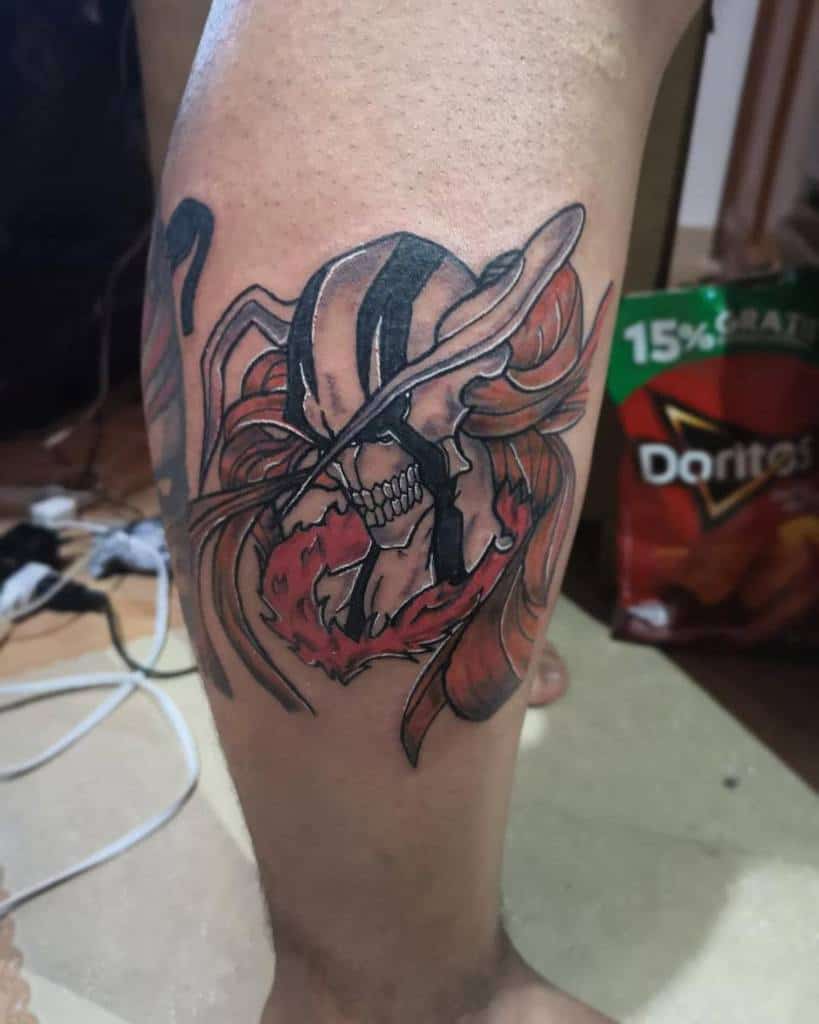 Colorful tattoo of Hollow Ichigo from Bleach, featuring his signature skeletal mask, fiery red aura, and intense expression 