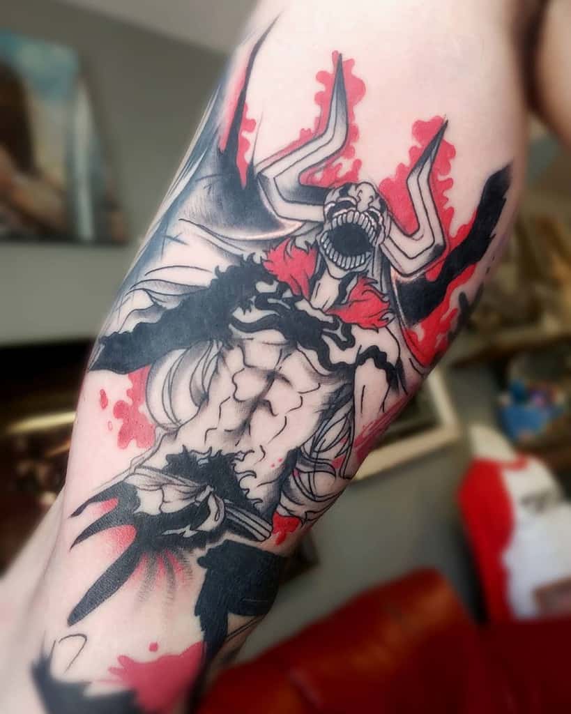 Black and red ink tattoo of Ichigo Kurosaki’s Vasto Lorde form from Bleach, featuring sharp horns, fierce expression, and fiery red aura 
