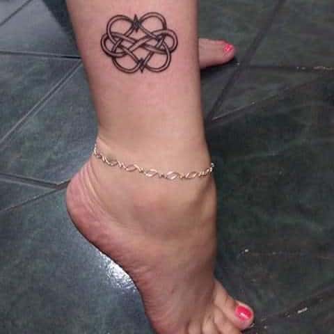 Tattoo of a geometric Celtic knot intertwined with an infinity symbol on an ankle