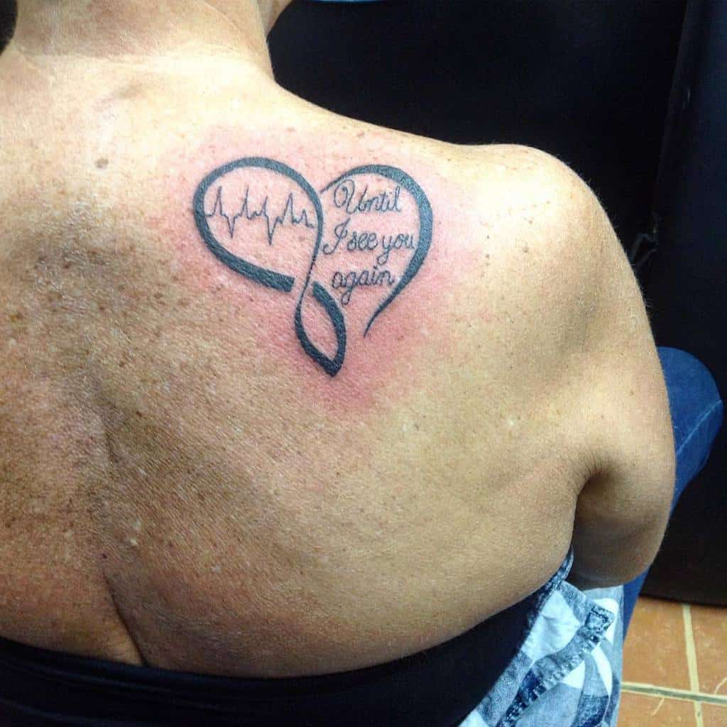 Heart-shaped infinity tattoo with a heartbeat and text "Until I see you again" on back