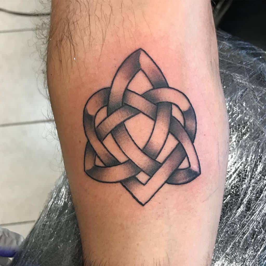 Tattoo of an interwoven geometric pattern forming a subtle heart on an arm