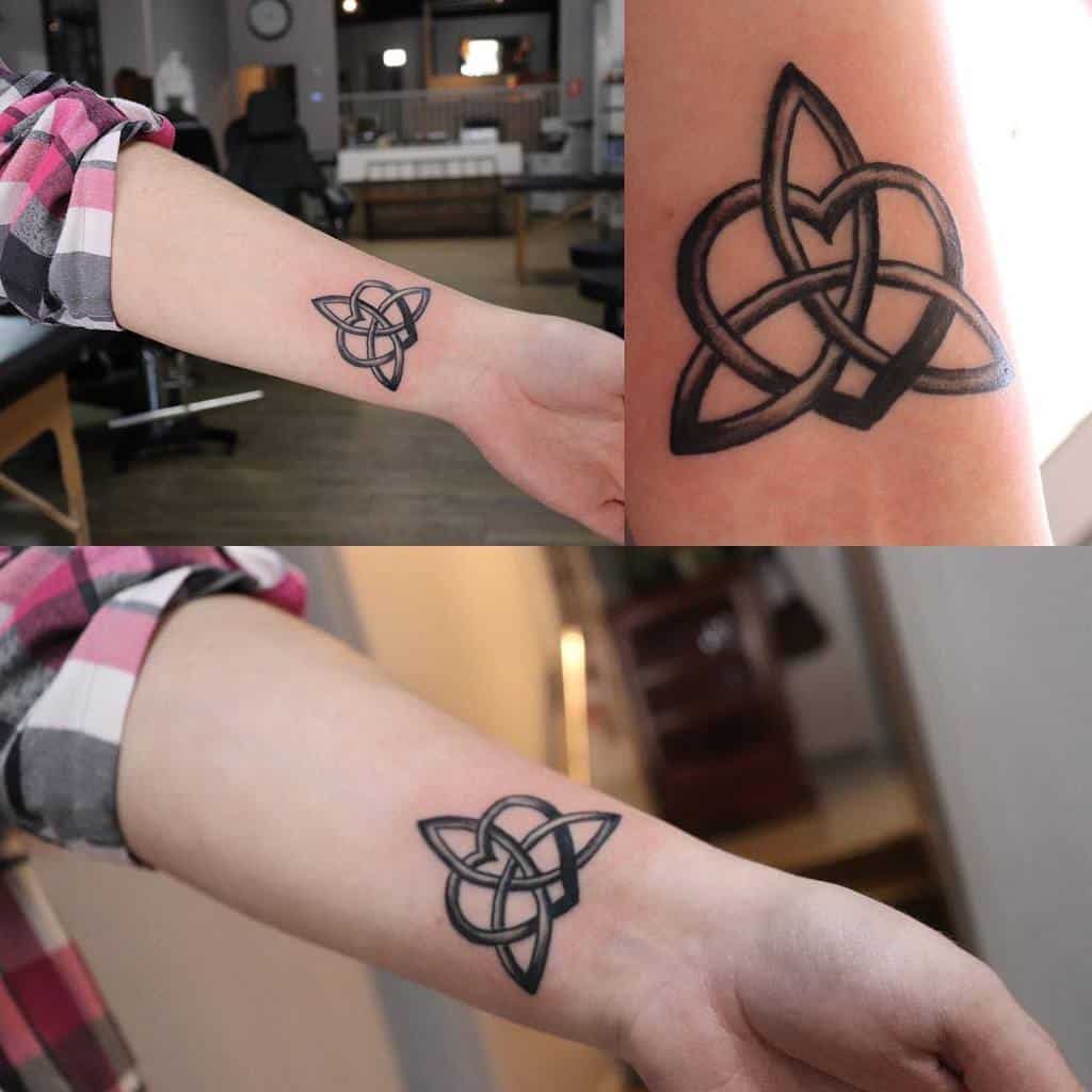 Arm tattoos showcasing intricate black Celtic knot designs intertwined with heart and infinity symbols
