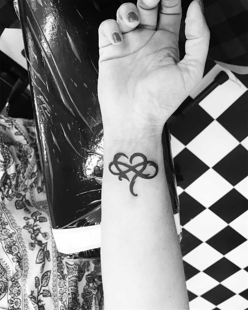 A tattoo of an infinity heart on a wrist
