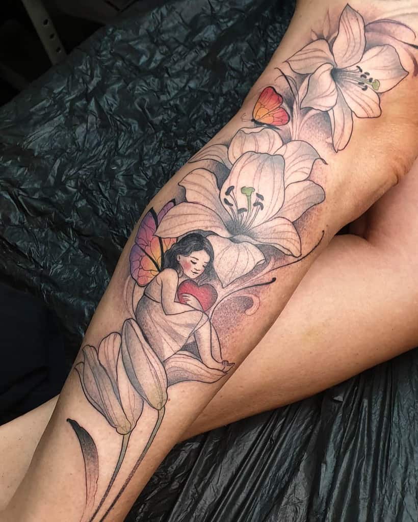 Whimsical tattoo of a fairy with butterfly wings cradling a heart, surrounded by blooming lilies