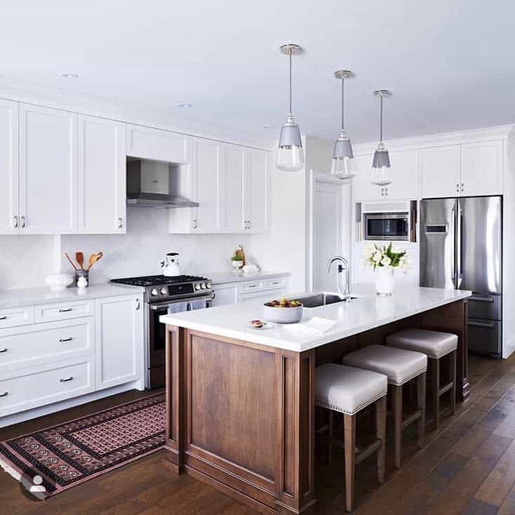 elegant white cabinet kitchen wood island three stools hardwood flooring