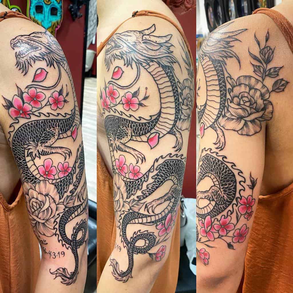 Dragon and floral tattoo on an upper arm