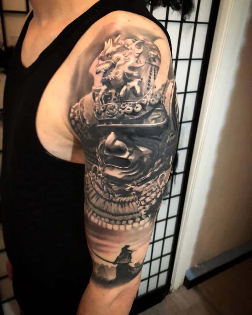 Man with a detailed samurai-themed tattoo sleeve on his arm