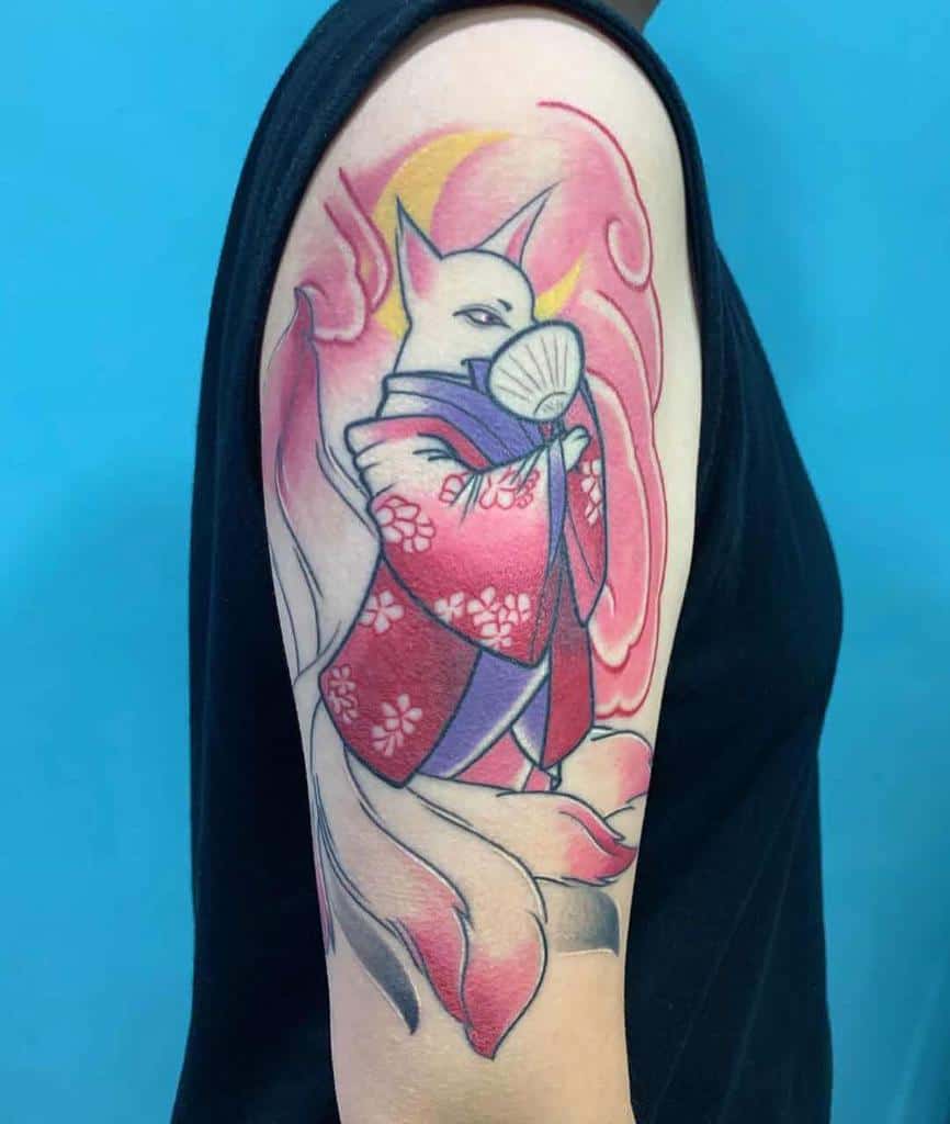 Tattoo of a fox in a red kimono with a fan on an upper arm