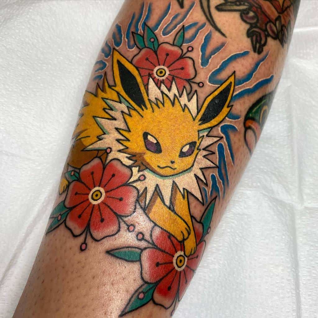 Bold Jolteon tattoo with vibrant electric blue sparks, surrounded by red flowers for a striking contrast of energy and nature