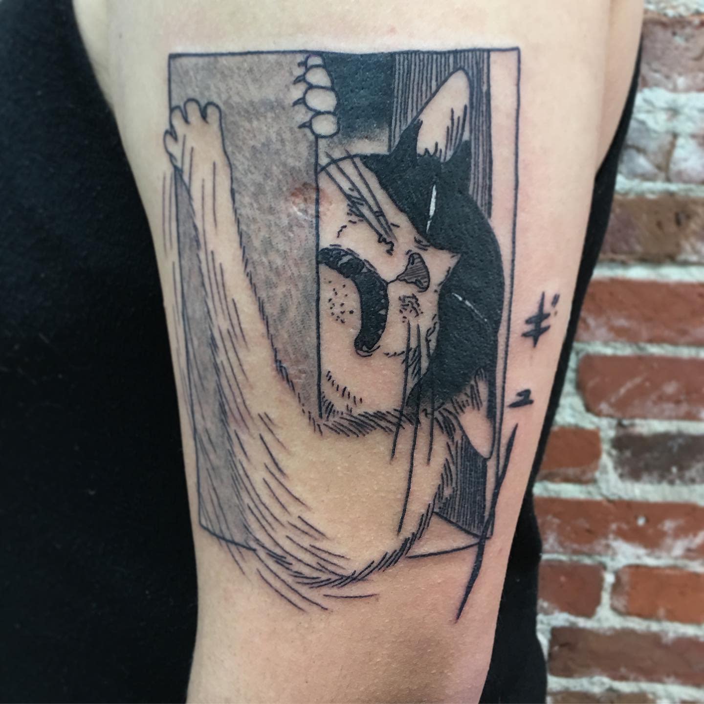 Arm tattoo of a distressed cat squeezing through a tight space, capturing Junji Ito's unique horror style