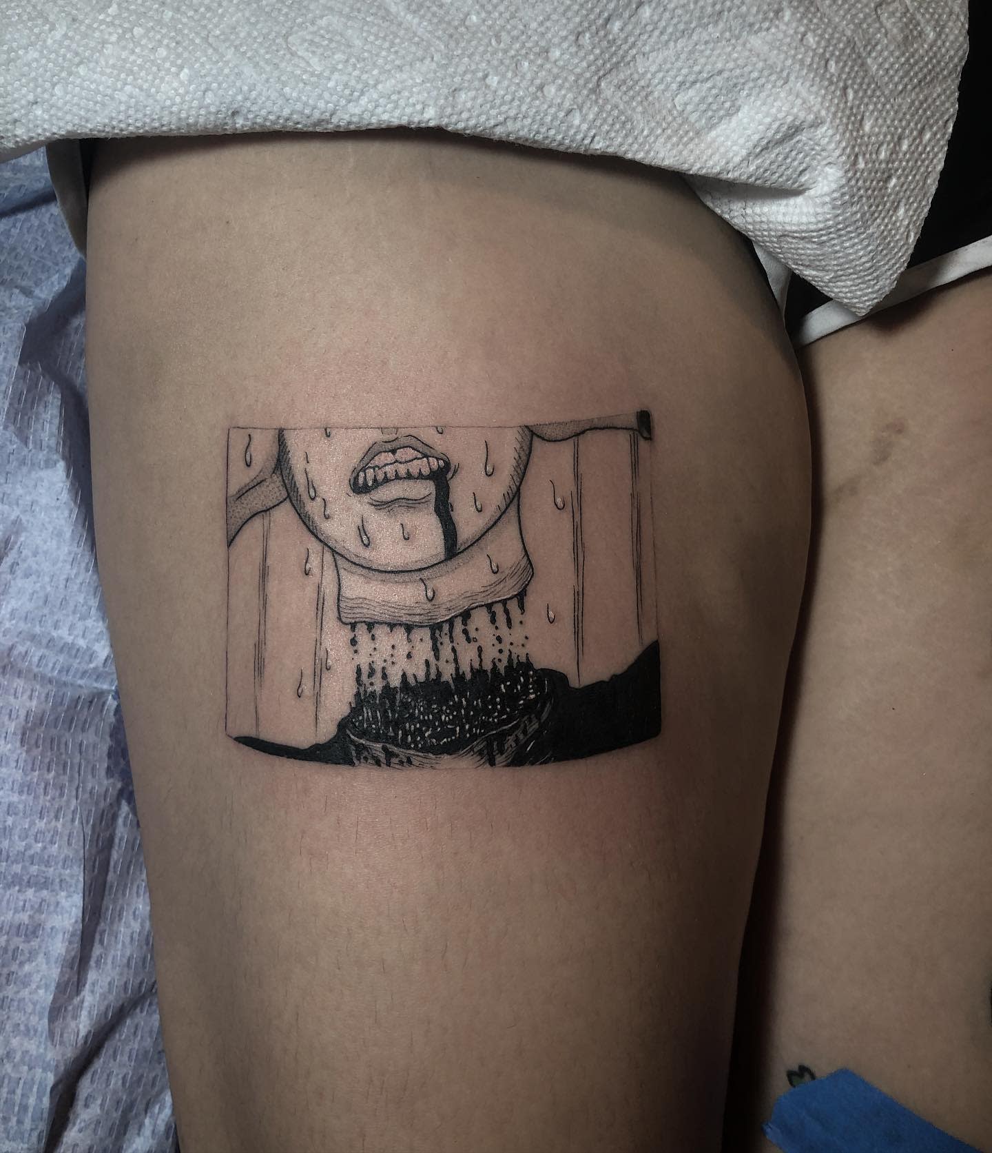 Thigh tattoo of a Junji Ito panel showing a sweating face with a black liquid pouring from its mouth