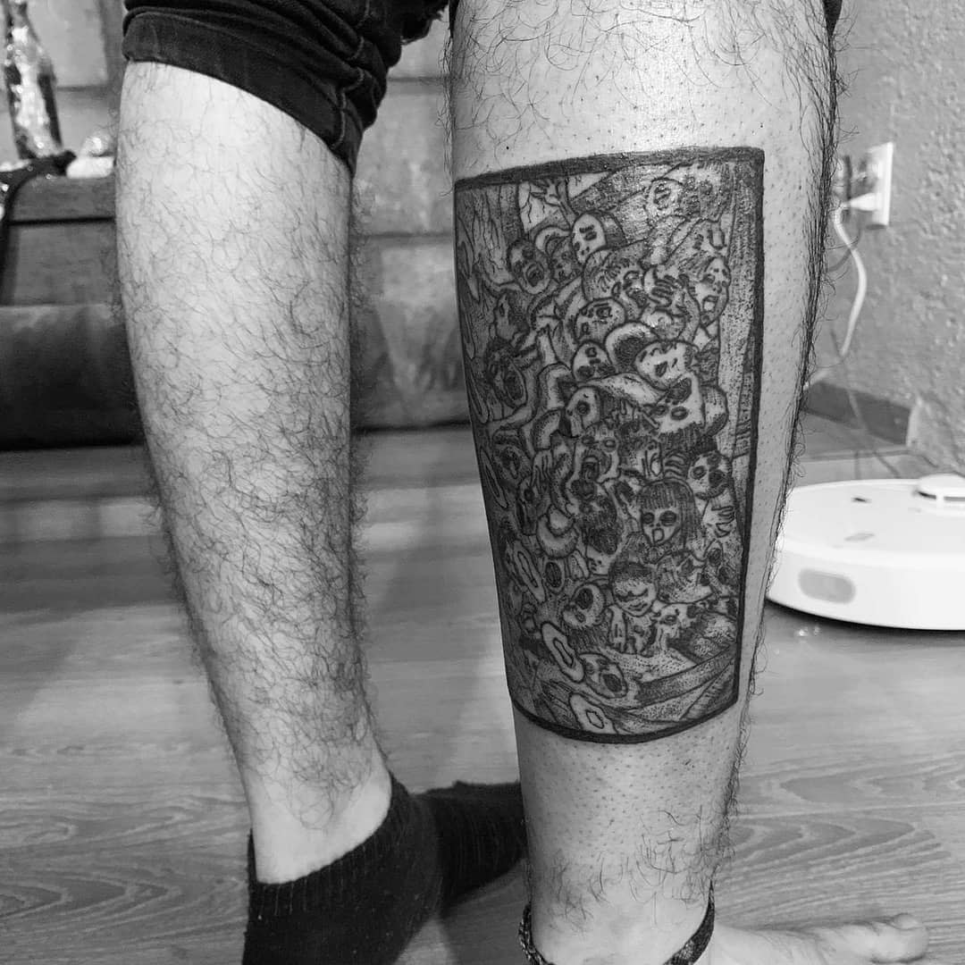 Calf tattoo of a densely packed scene from Junji Ito's 'Uzumaki,' featuring countless distorted faces swirling in chaos