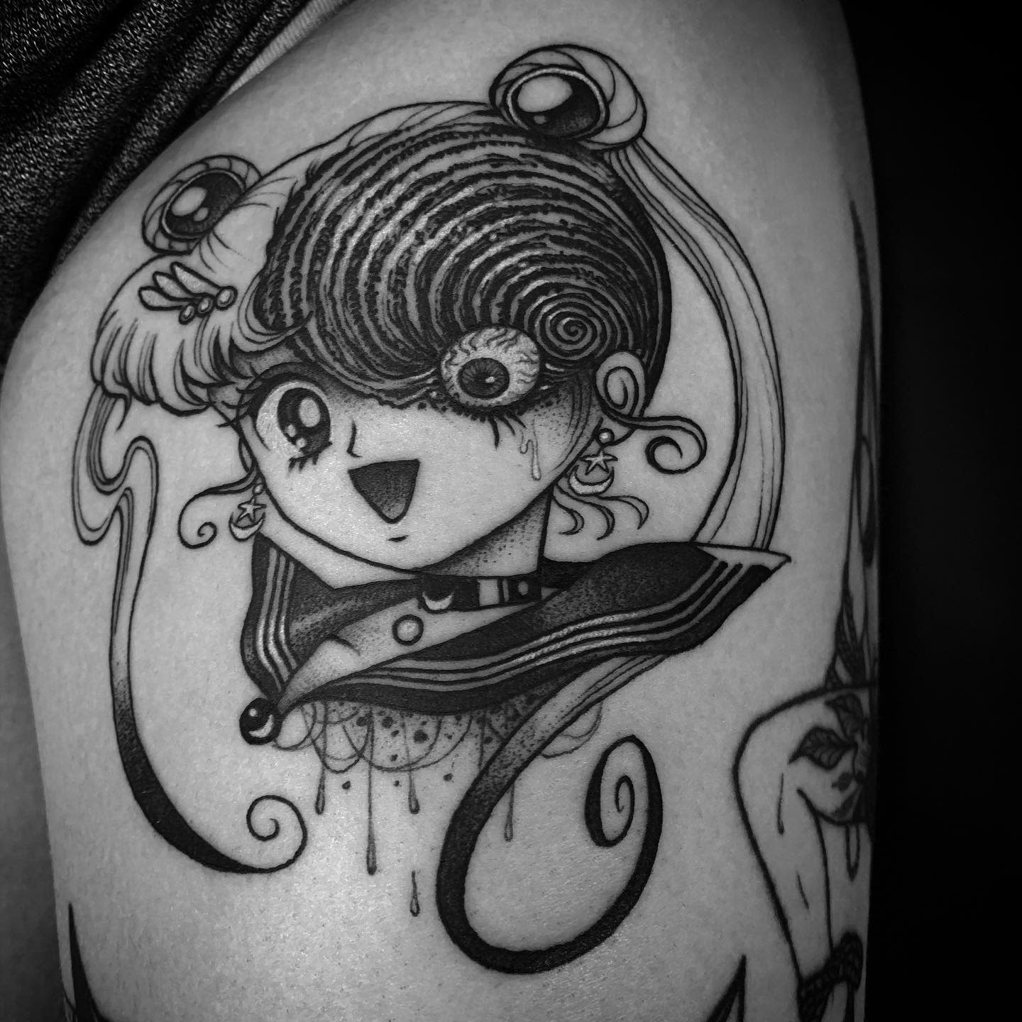 Junji Ito-inspired tattoo featuring a character with spiral patterns in her hair, capturing the eerie essence of 'Uzumaki'