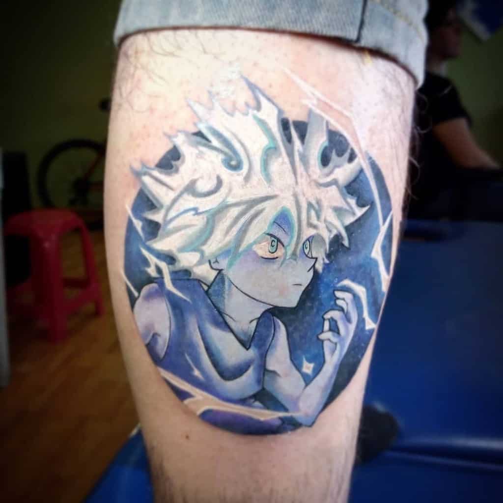 Dynamic and colorful Killua Zoldyck tattoo from Hunter X Hunter, featuring his intense expression with electric blue accents and a strong action pose