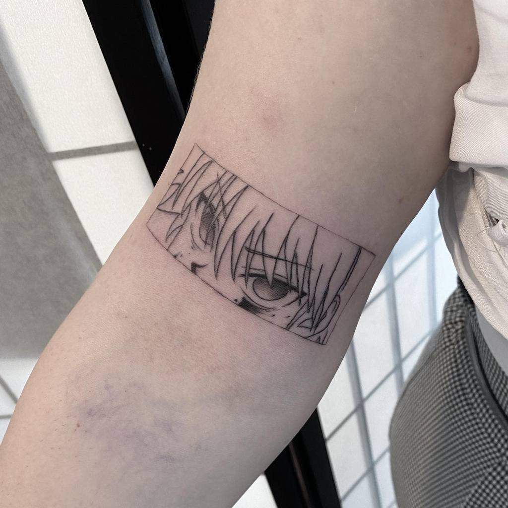 Minimalistic Killua Zoldyck tattoo from Hunter X Hunter, capturing his intense gaze in a narrow rectangular frame with fine black linework