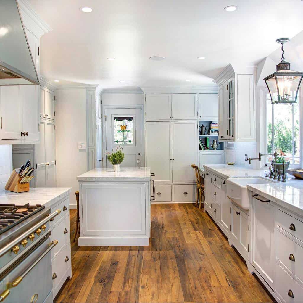 large white kitchen with apron sink and island