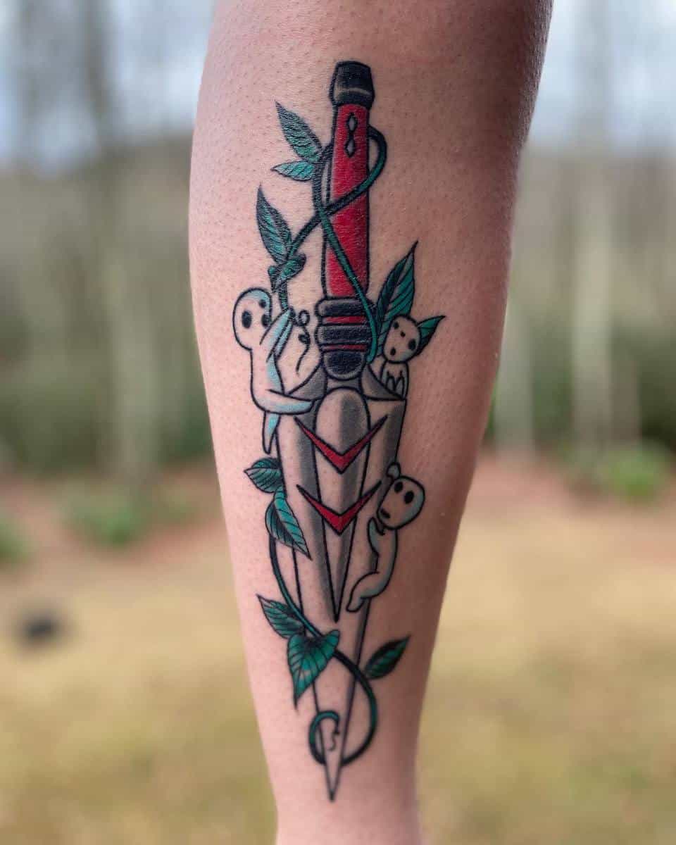 Tattoo of Kodama spirits from Princess Mononoke climbing San's red dagger entwined with vines