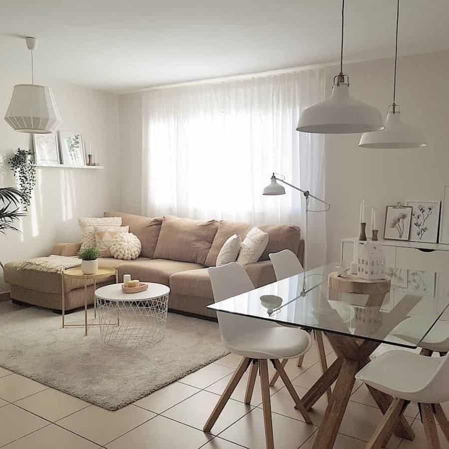 glass table white chairs beige sofa gray rug pendant ceiling lights
