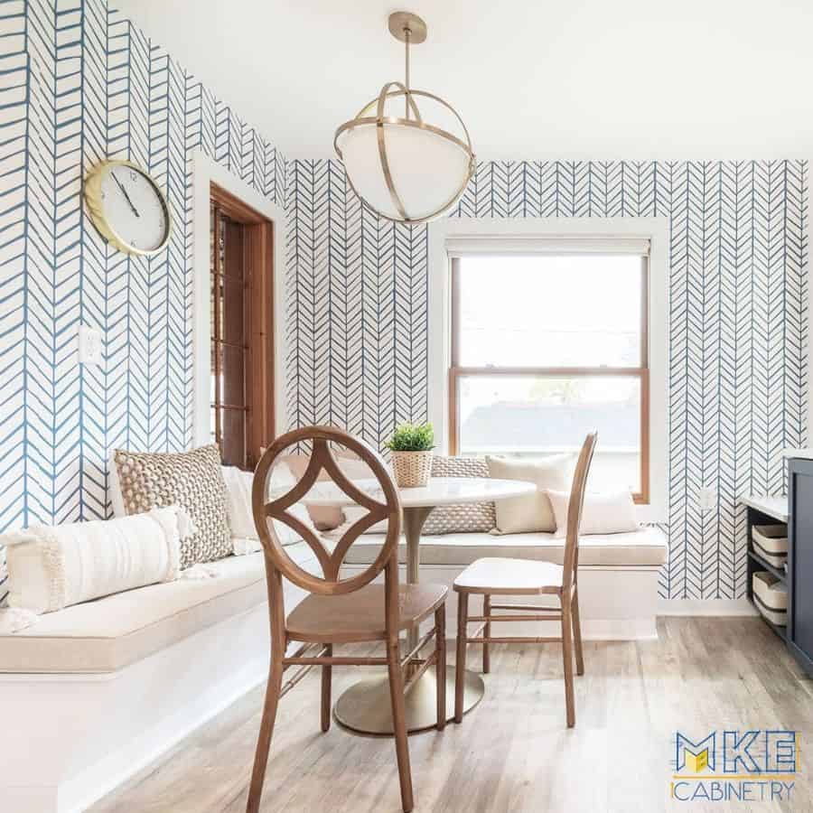 pattern wallpaper small table and chairs circular ceiling pendant light