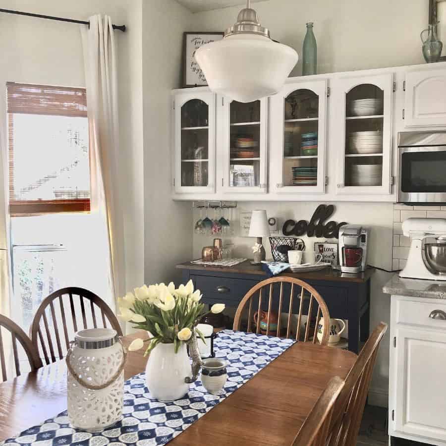 cluttered rustic kitchen dining room table and chairs large globe pendant light