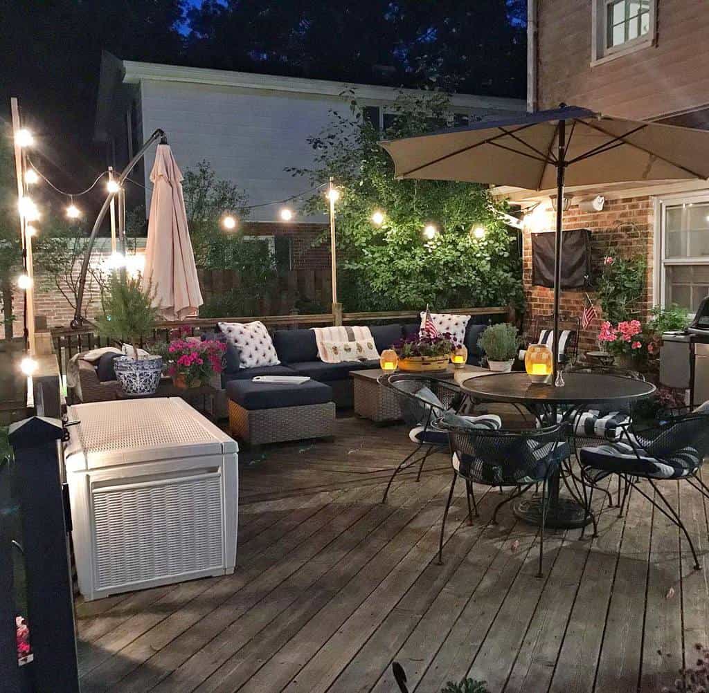 wood deck outdoor table wicker sofa strung up lights
