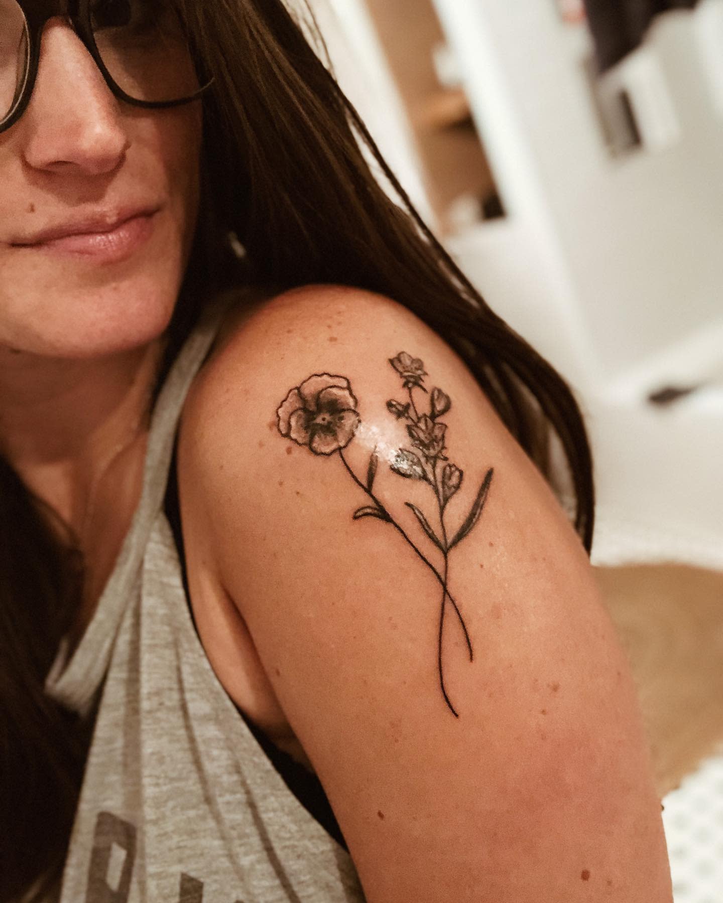 Woman with floral tattoo on her upper arm