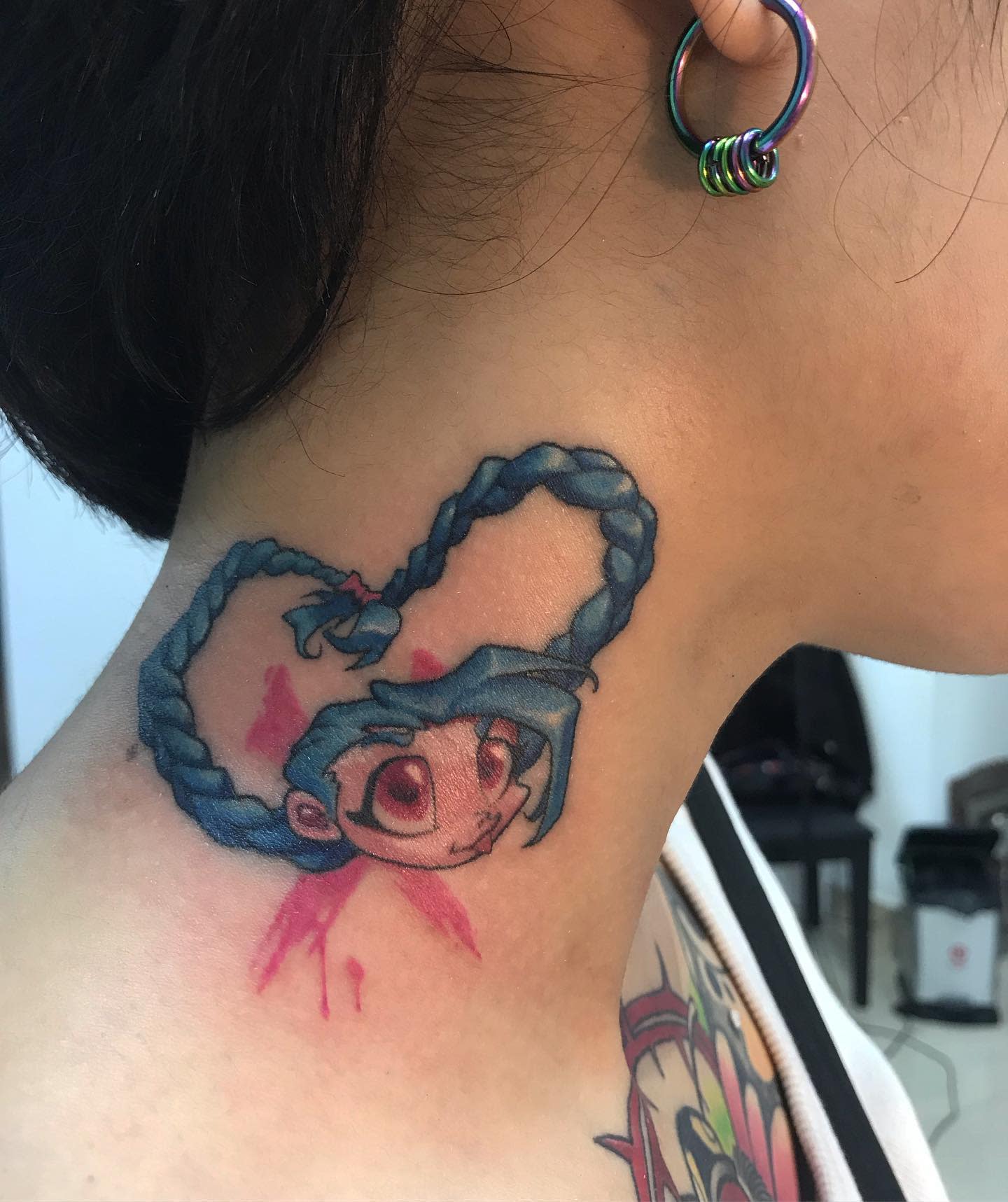 Colorful tattoo of Jinx from League of Legends, with her iconic blue braids forming a heart shape
