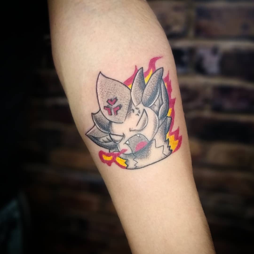 Small, colorful tattoo of Veigar from League of Legends, depicted in a chibi style with flames in the background